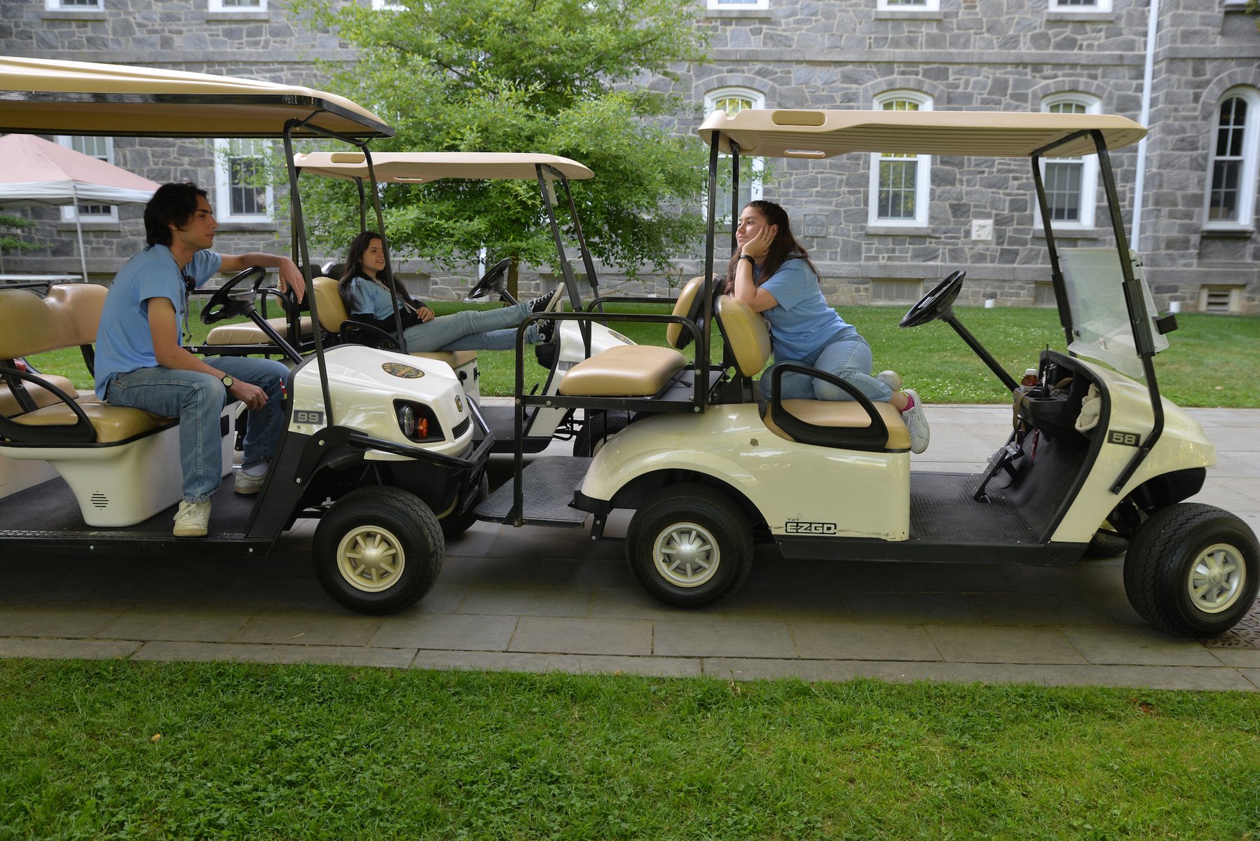 Students wait for passengers in their golf carts