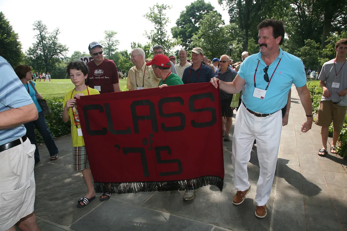 A group holds a banner that reads Class of 1975
