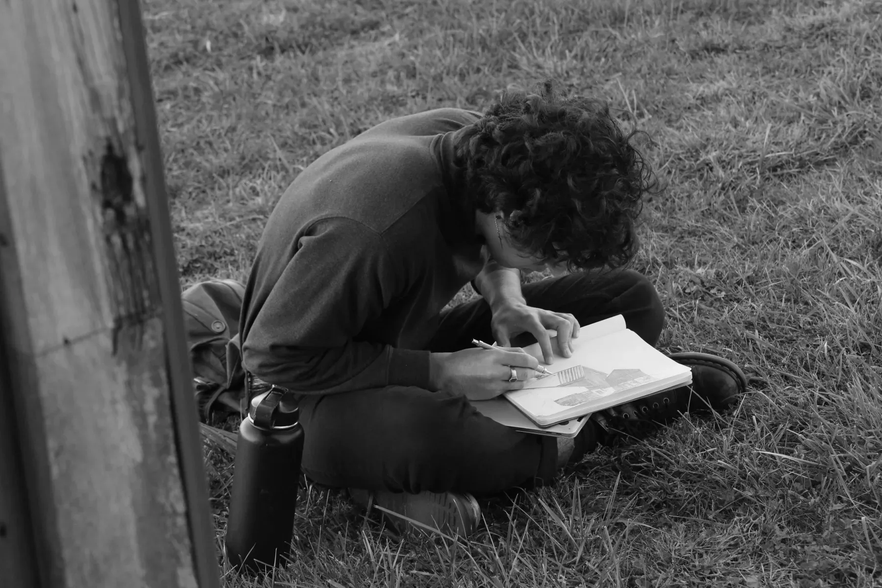 Student sketching a barn during a Painting field trip.