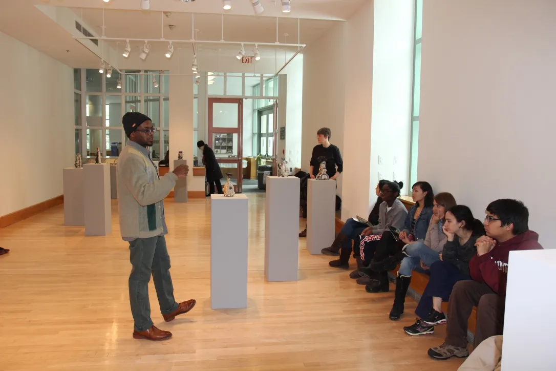 Artist Kevin Snipes speaking to Art program students inside the List Gallery.