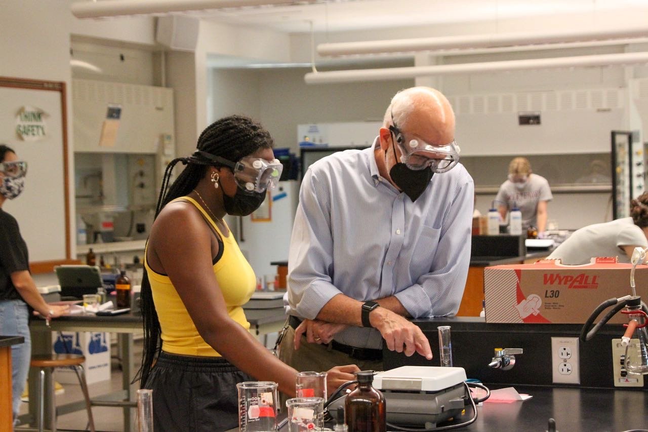 professor and student in goggles in the lab