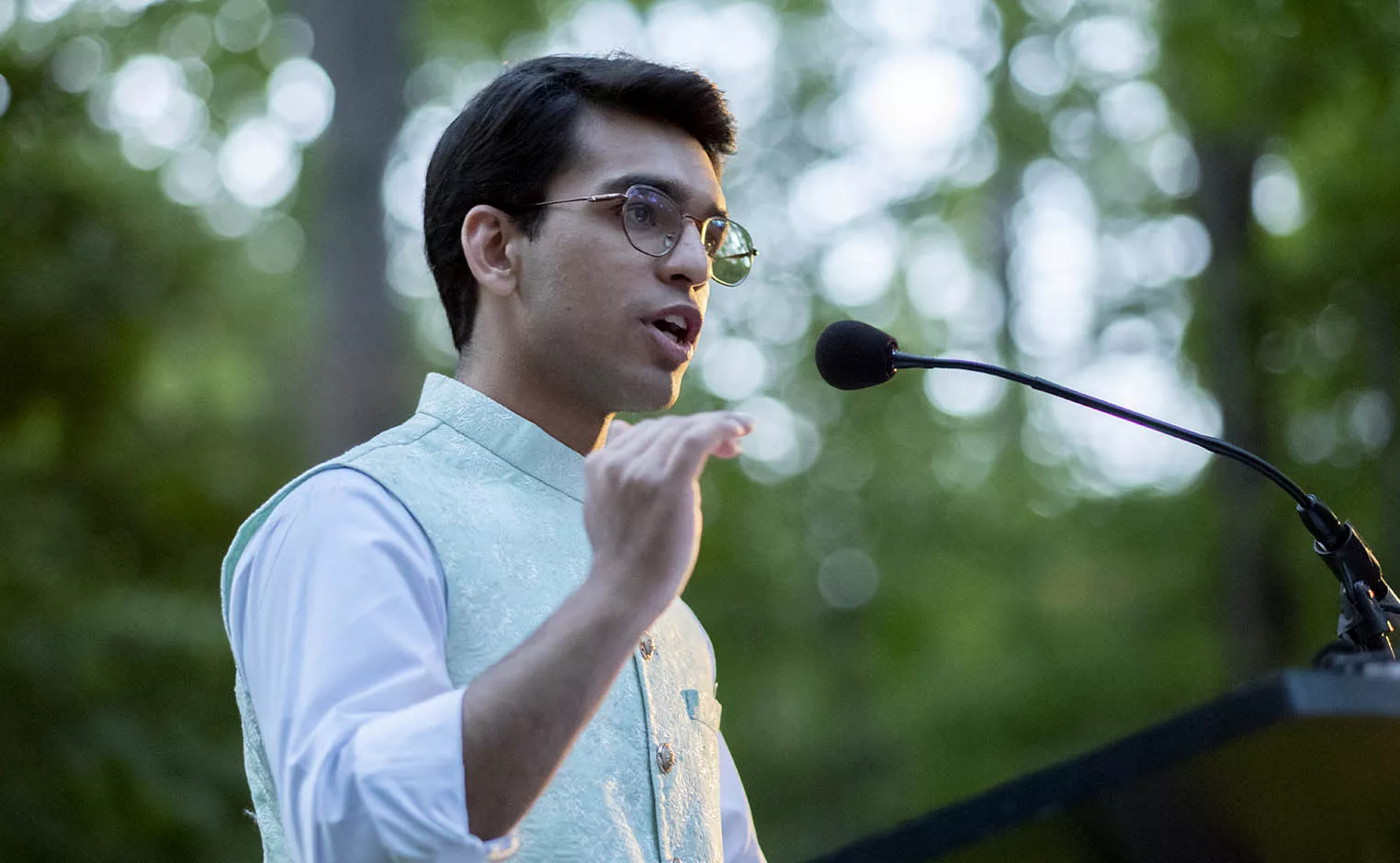 Sannan Dhillon speaking at podium