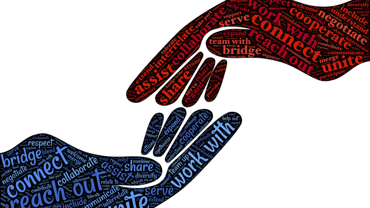two hands touching with words of unity