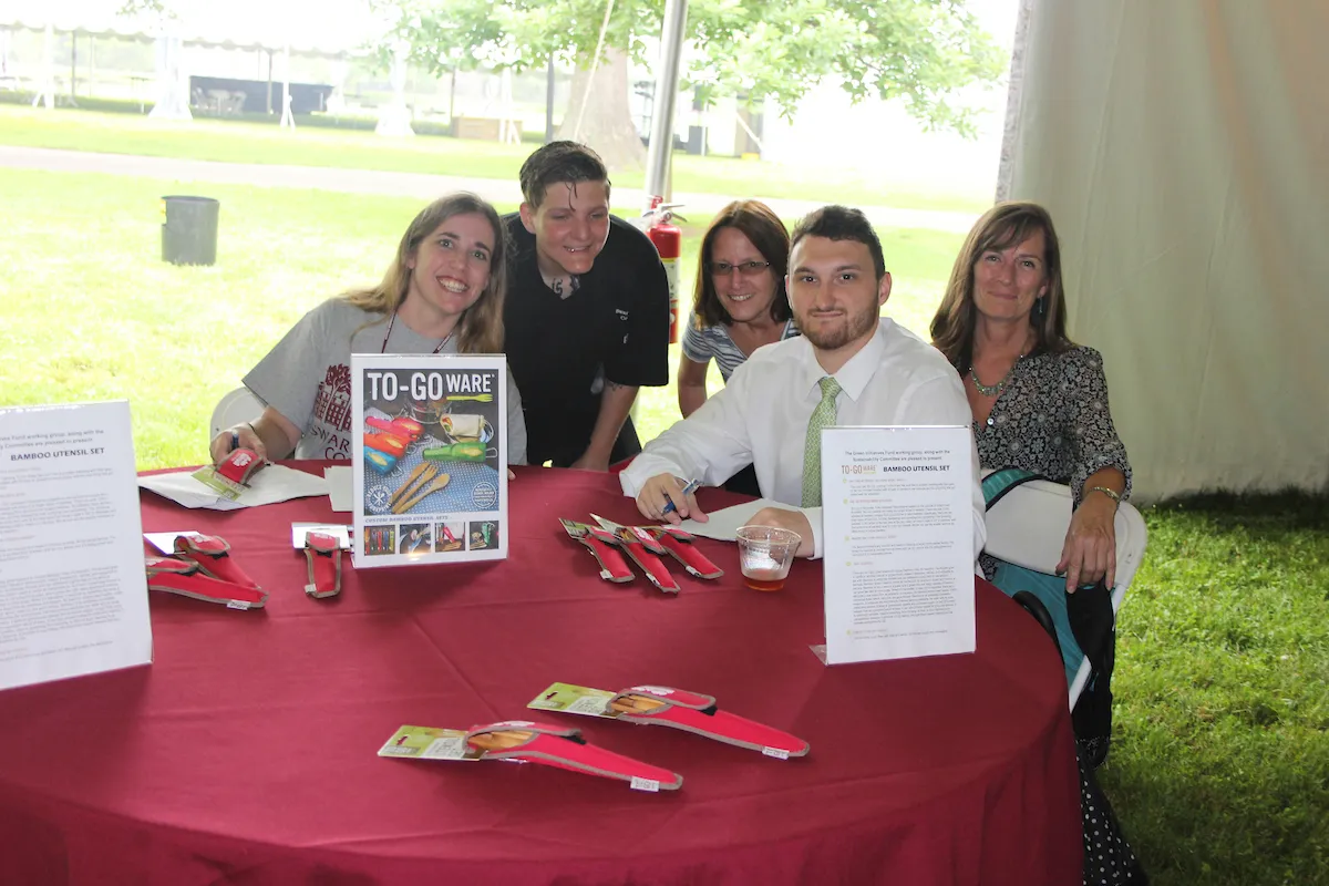 staff handing out reusable utensils