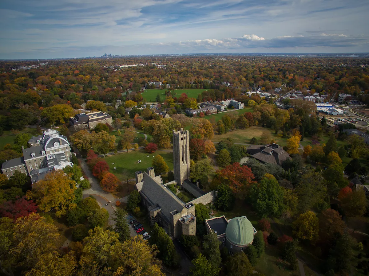 Aerial drone photography of the campus displaying the fall foilage and skyline