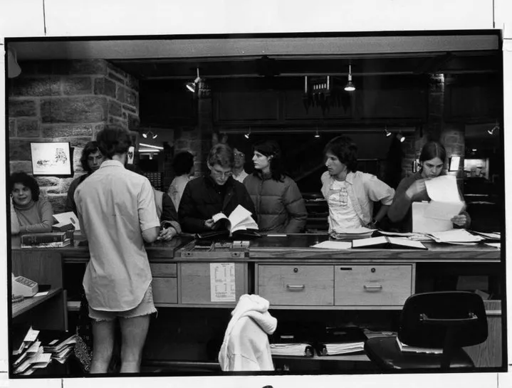 historical photo of students in line at the front desk of McCabe shortly after it opened around 1970