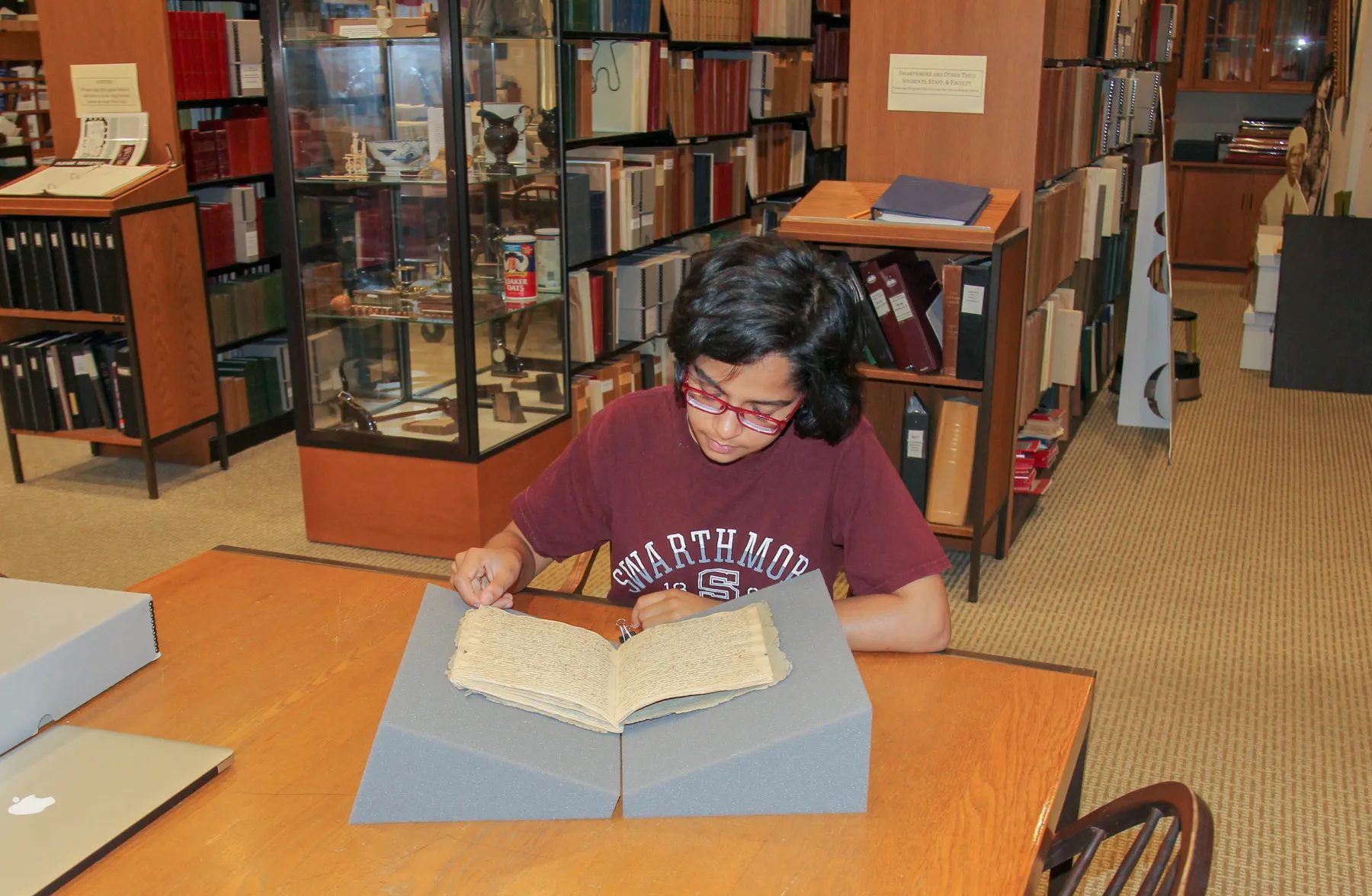Student reading a manuscript in the Special Collections Reading Room