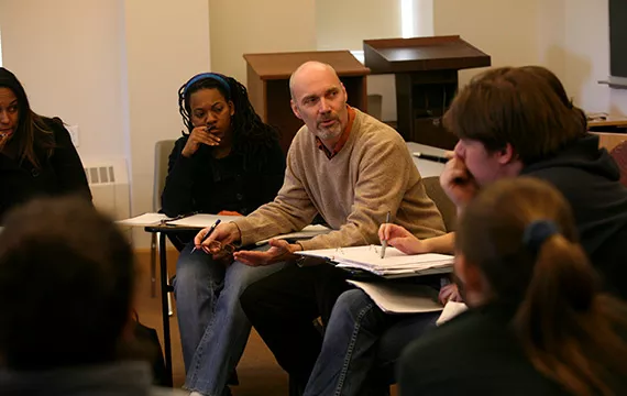 A professor discusses the topic amongst the students in class.
