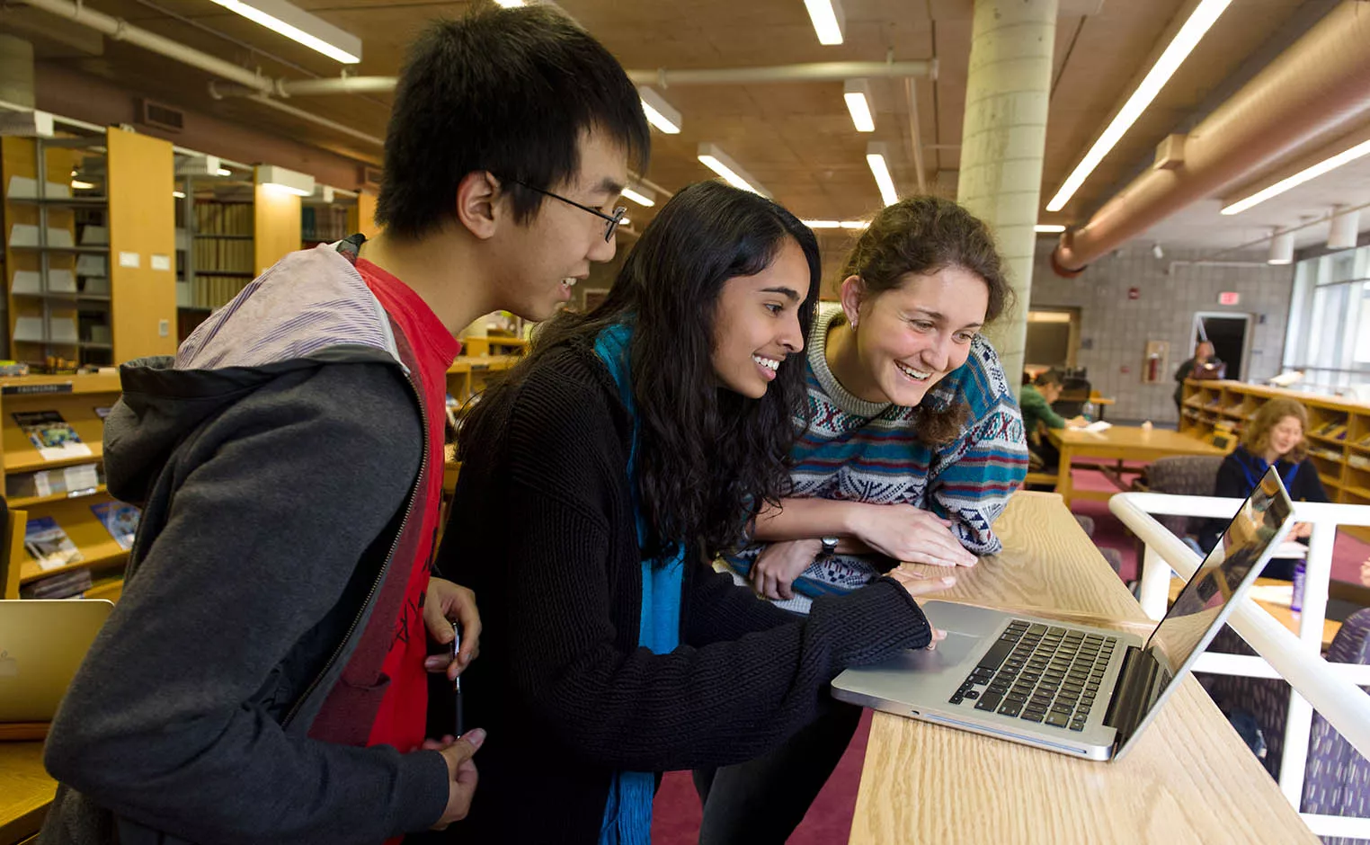 students looking at a laptop together