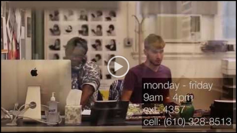 Two student employees at the Help Desk - a picture from the video they created.