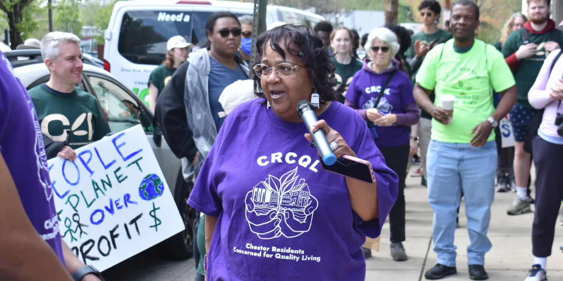 photo of ms zulene holding mic and protesters at EJ march