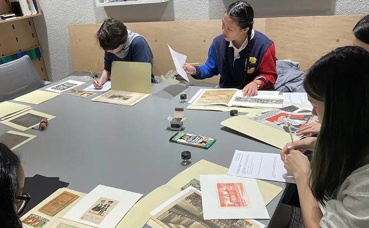 Students work with archival materials in the library