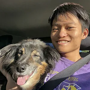 Ethan Liang seated with his dog