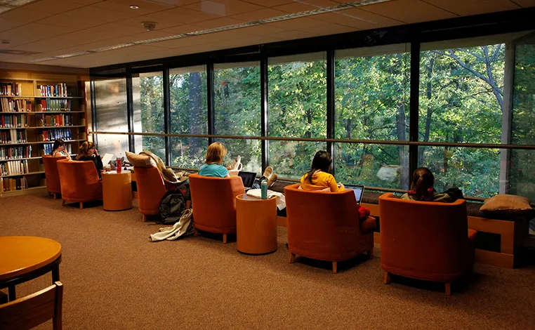students study in Underhill looking out over the Crum Woods