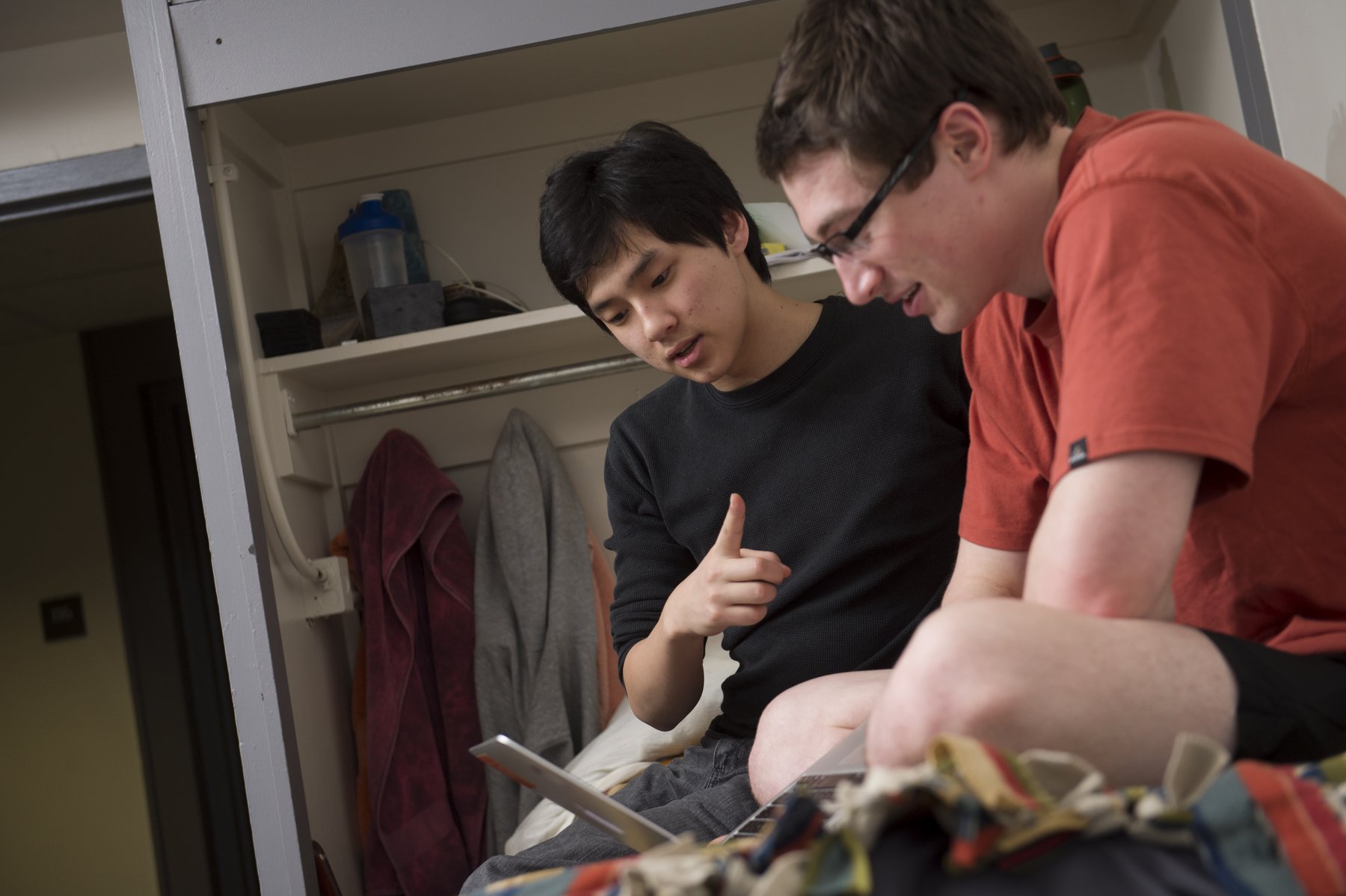 two students look at a laptop together