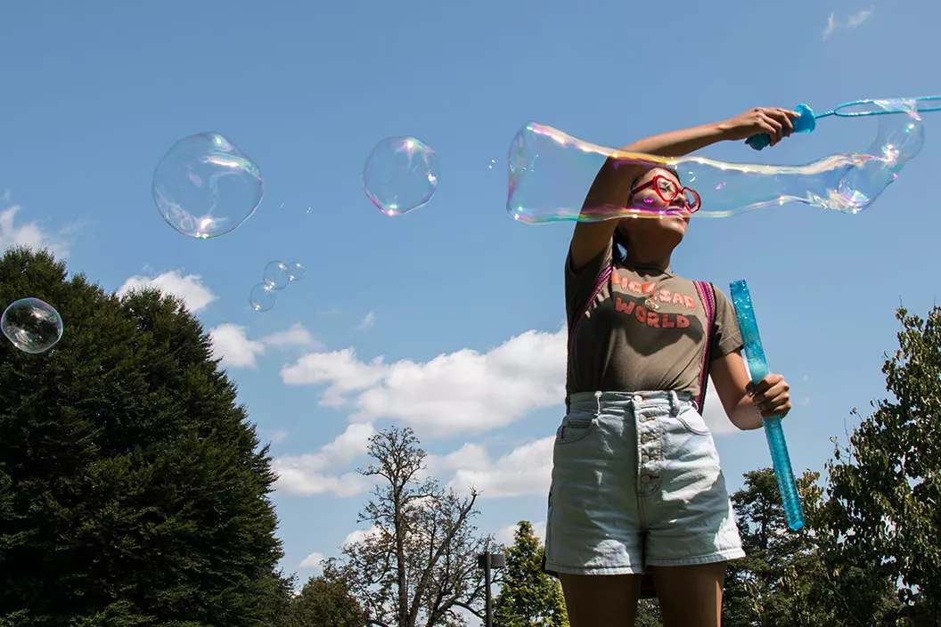 Student blows bubbles on Parrish Beach