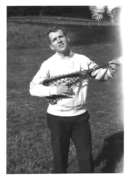 James Michener '29 holding a lacrosse stick like a guitar