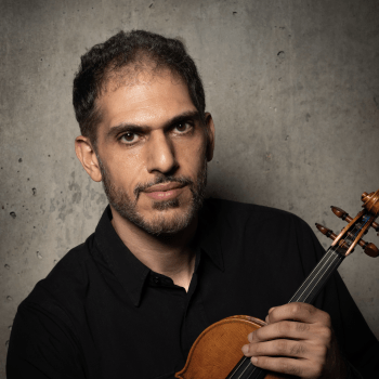 Cyrus Beroukhim holding a violin