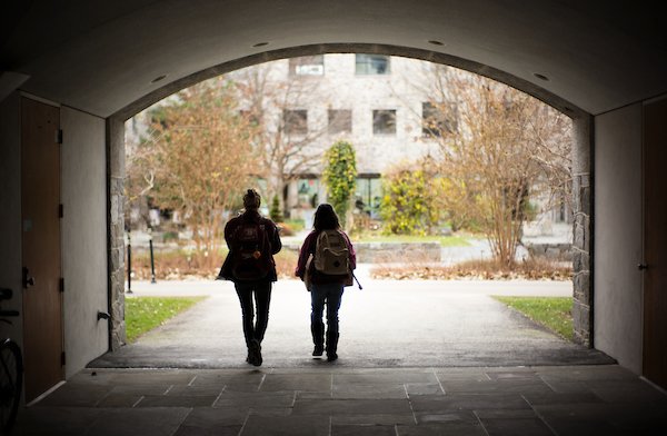 two students walking through Kohlberg breezeway 