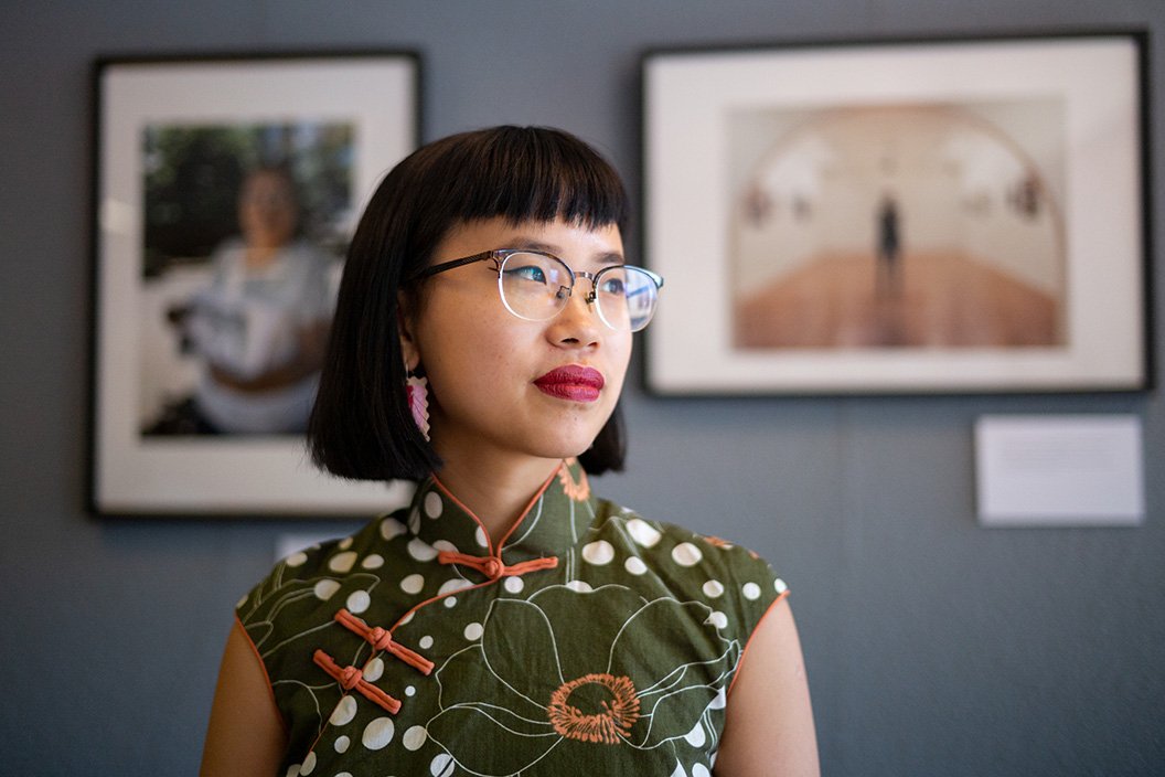 Dorcas Tang '19 in front of framed photographs