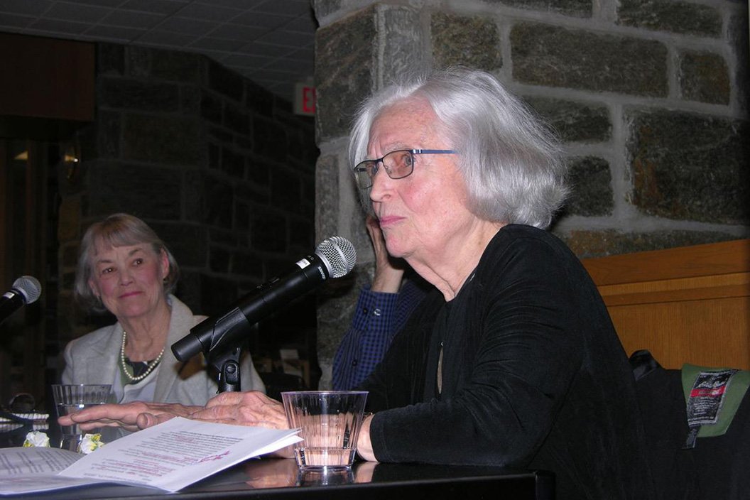 Betty Medsger sitting at table with microphone