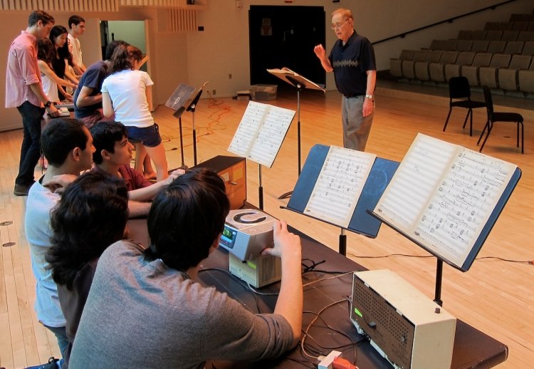 James Freemon conducts an orchestra during rehearsal
