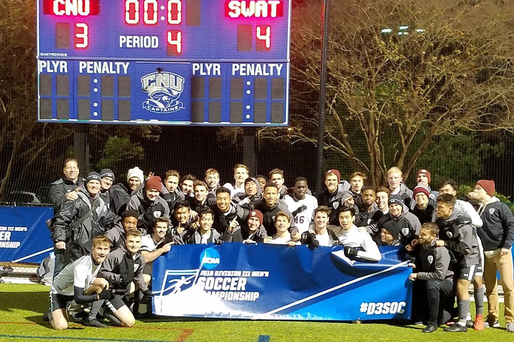 Swarthmore men's soccer team poses with NCAA banner in front of scoreboard