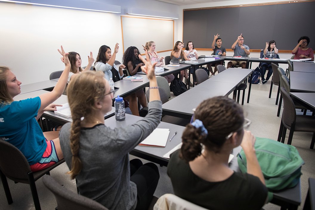 Students practice signing in ASL during class