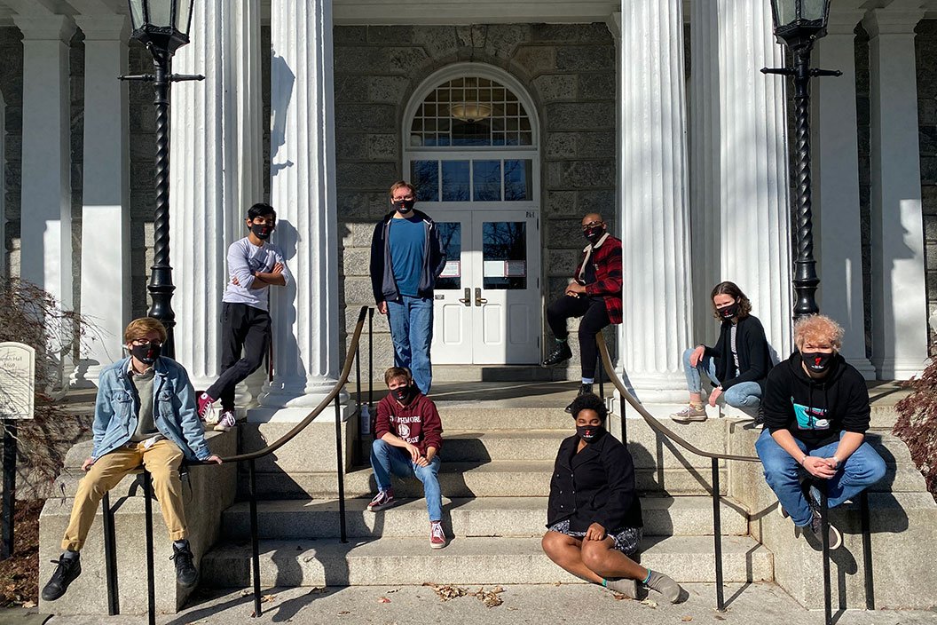 Students sitting outdoors on steps of Parrish Hall