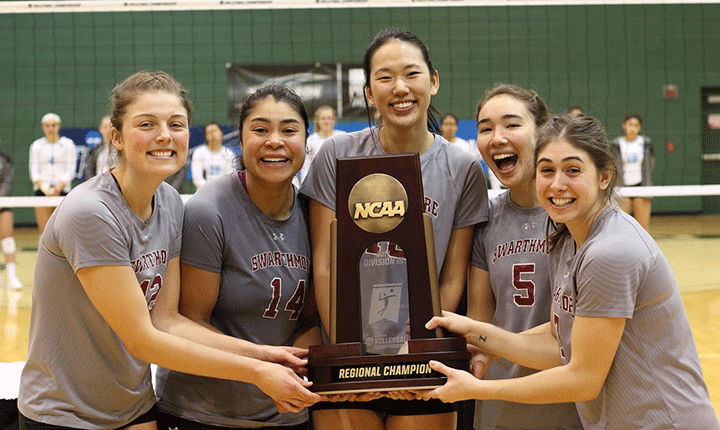 Members of the Swarthmore Volleyball team pose for a photo with the regional championship trophy