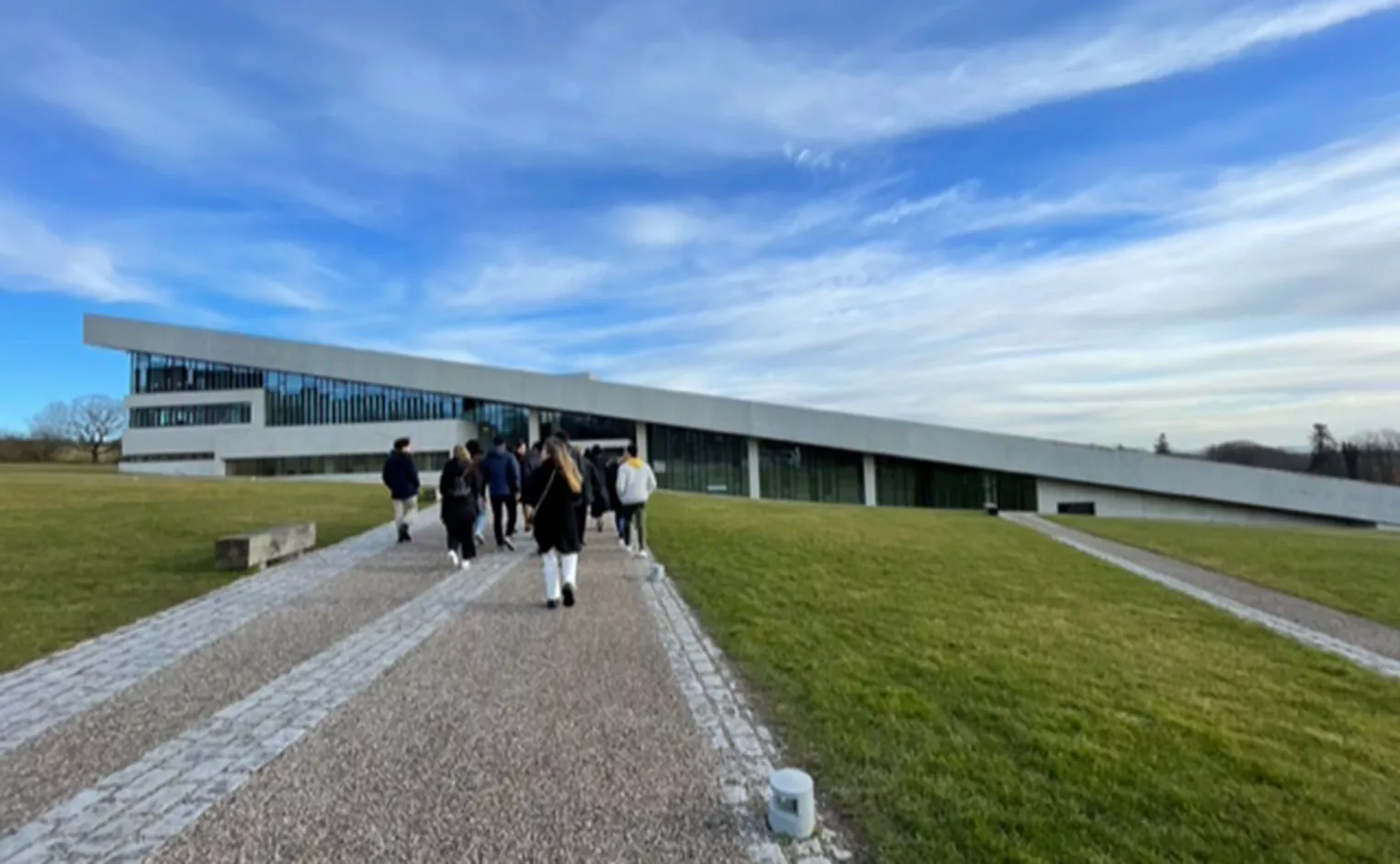 students walking toward a building in open landscape in Denmark