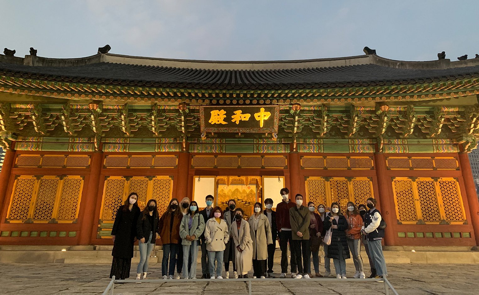 Nora in front of building in South Korea with group