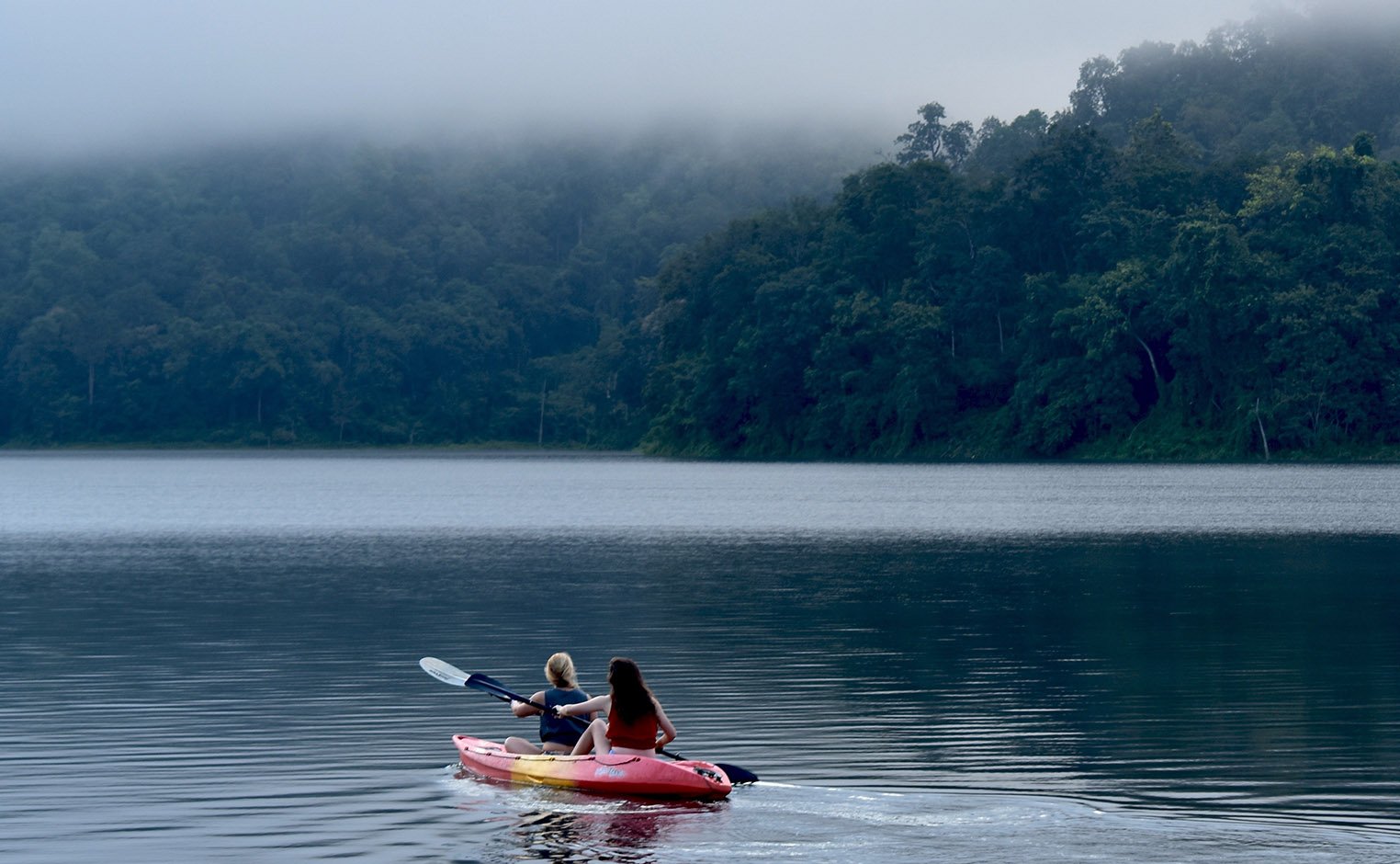 2 students in a canoe on a lake 