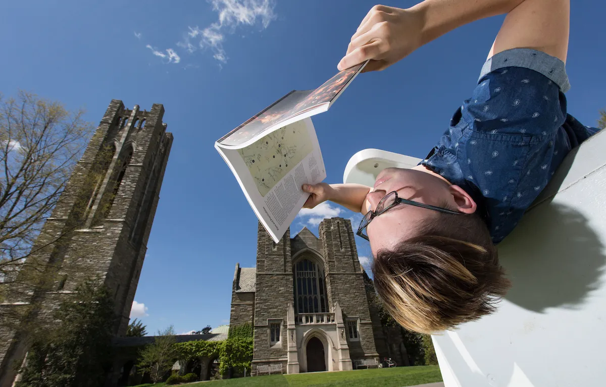 Student reading in front of Clothier Hall