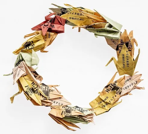 A chain of oragami cranes laid out in a circle.