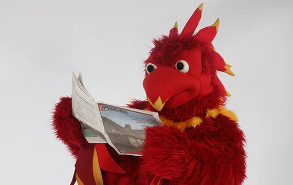 Phineas the Phoenix reading newspaper