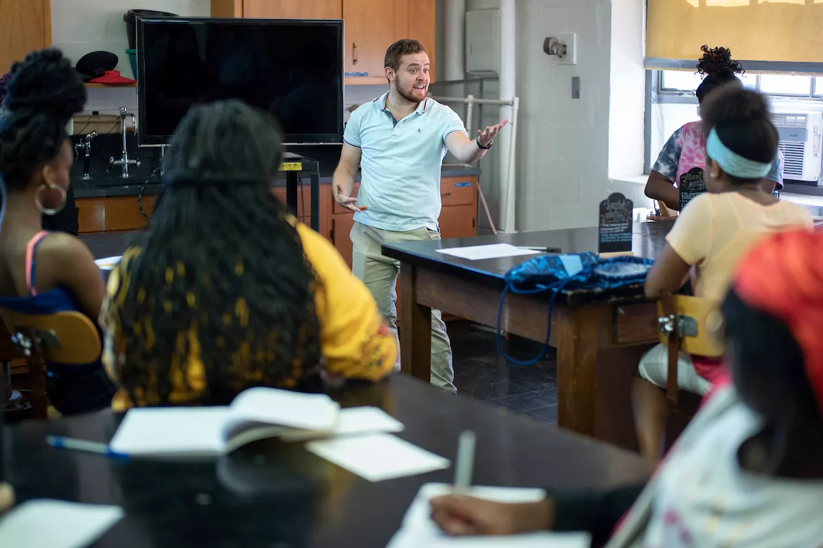 Student tutor addresses a room of students in Science for Kids