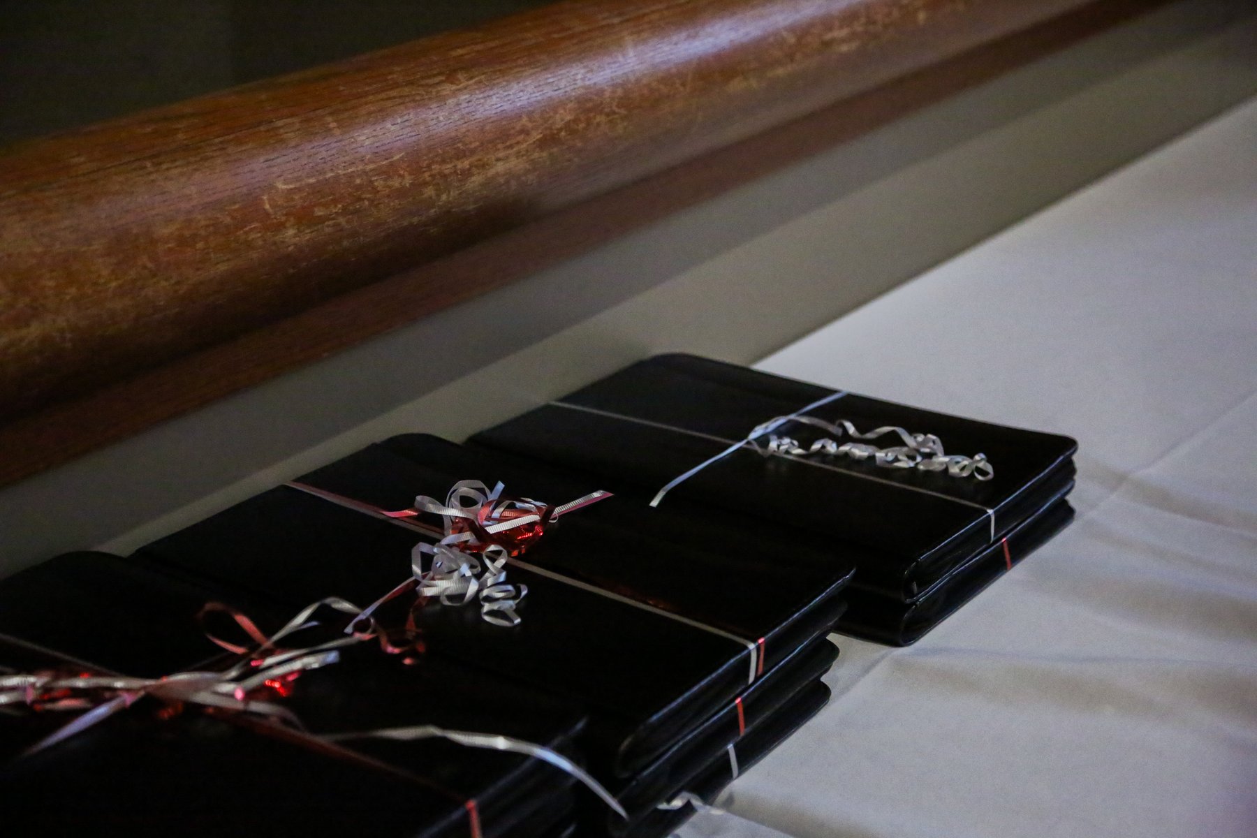 Black folders with ribbon on a table