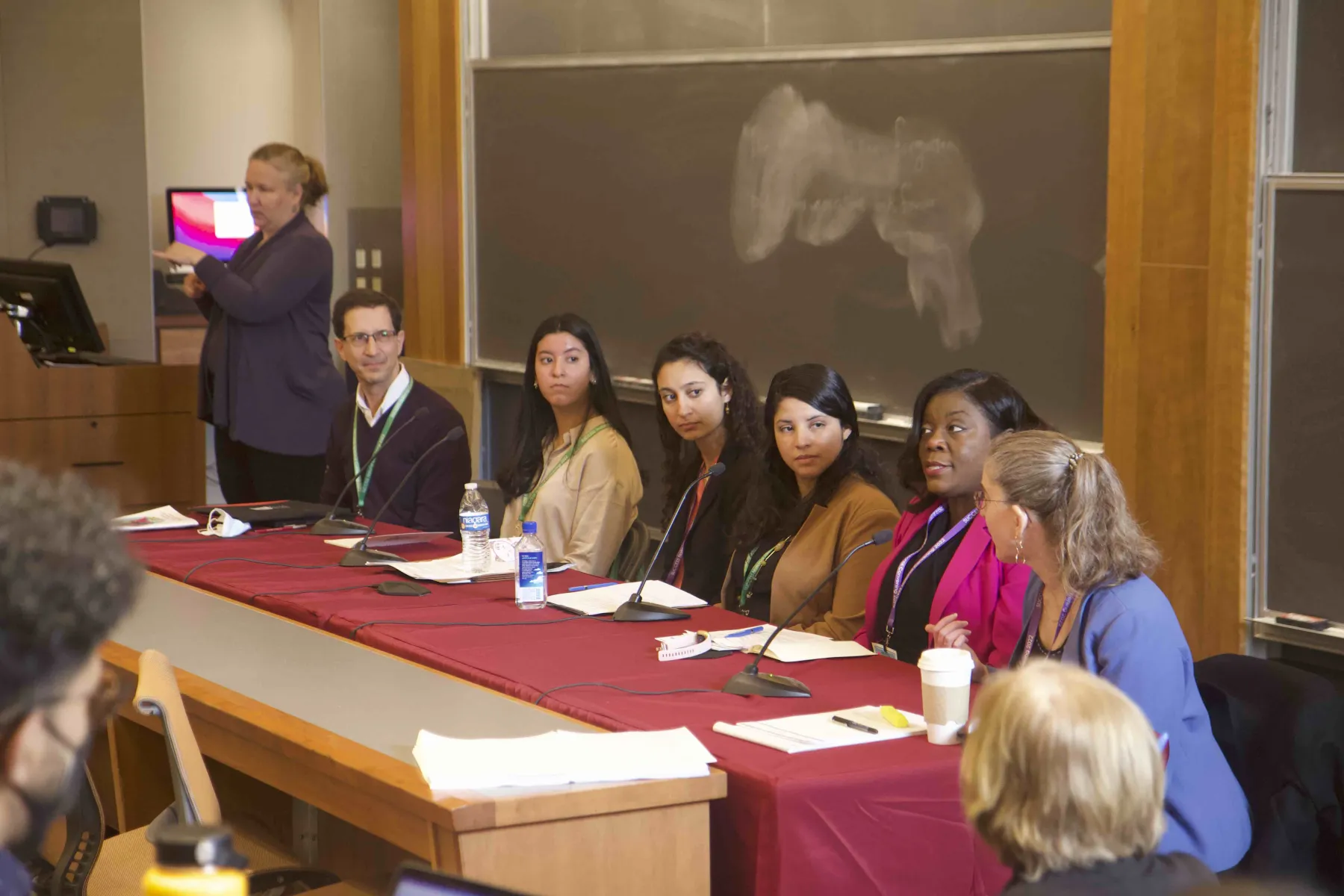 Panelists at a conference listen while one speaks.