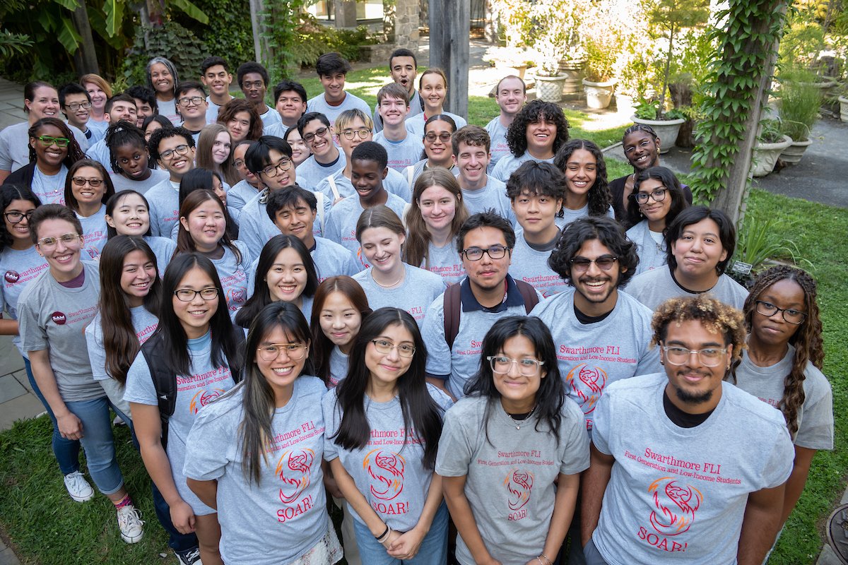 Group of smiling students wearing gray Swarthmore FLI t-shirts
