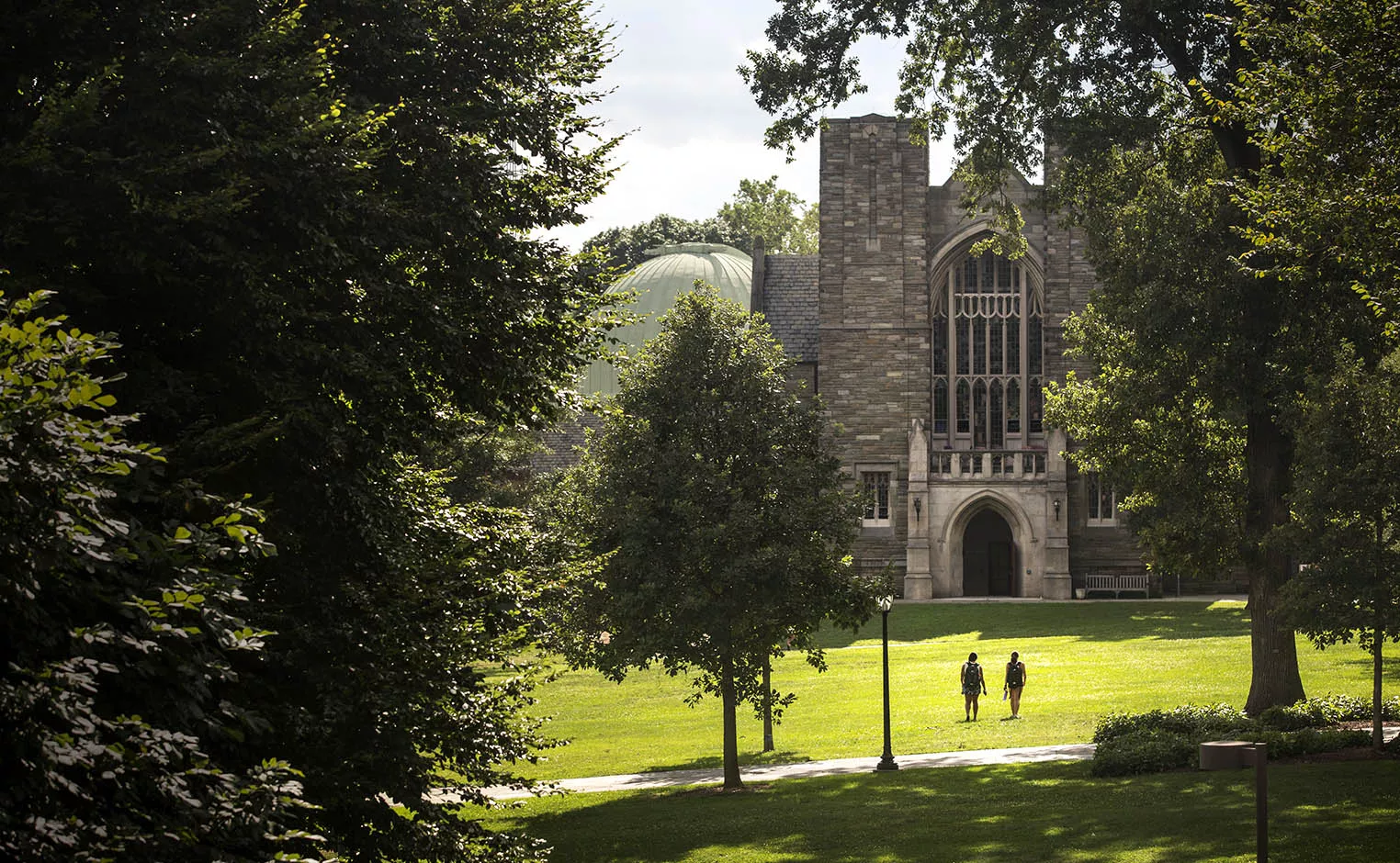 two students walking towards clothier hall
