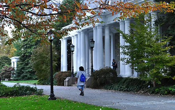 Image of student walking in front of Parrish Hall