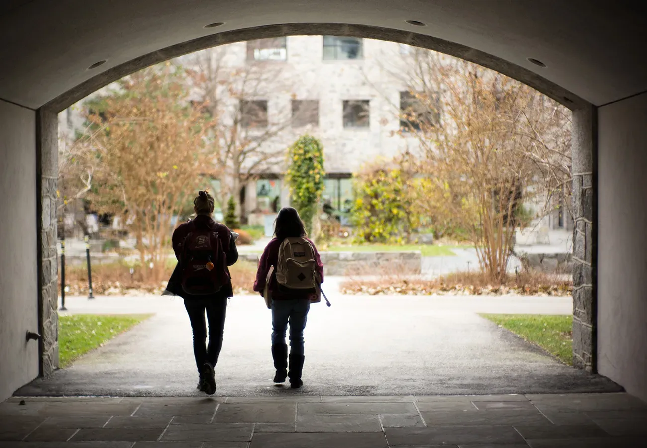 two students walking to kohlberg hall