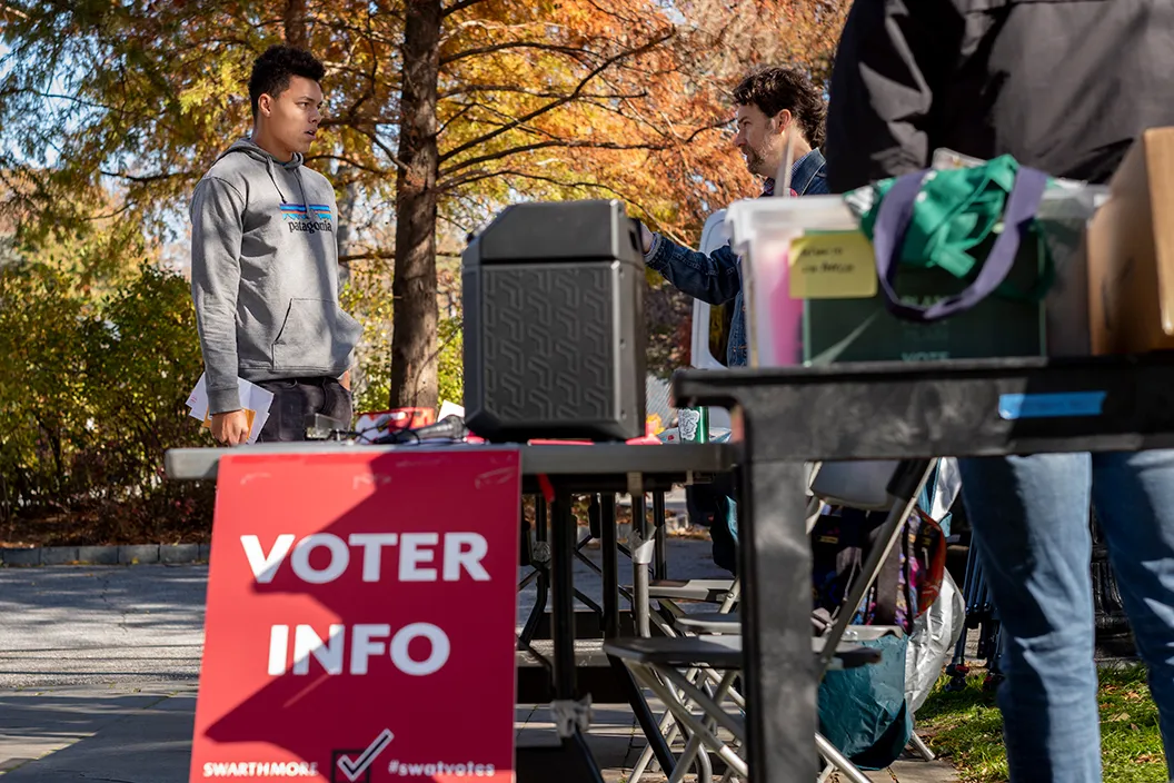 Student receives info at voter information table outside