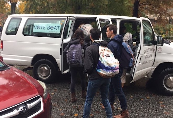 Students getting into a van with a sign that says "Vote Boat"