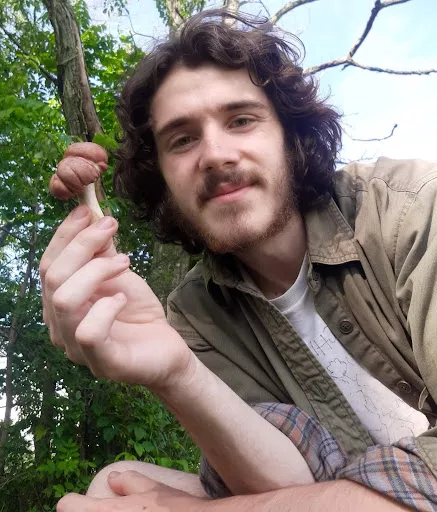 Portrait of Greg Boatman holding a mushroom