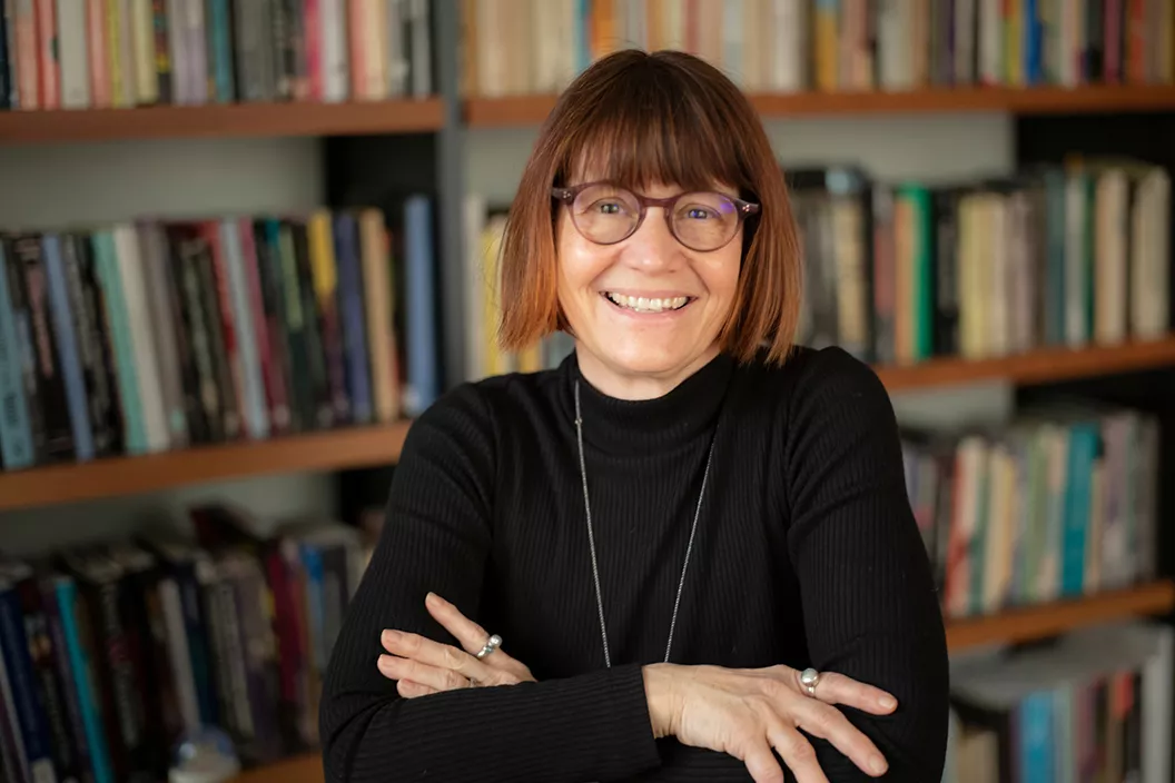 Patty Whitein office in front of bookshelves