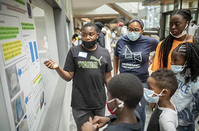 students sharing their research with others