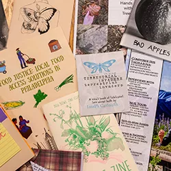 Collection of zines stacked on table