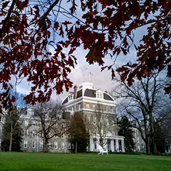 Parrish Hall in background with changing leaves in foreground